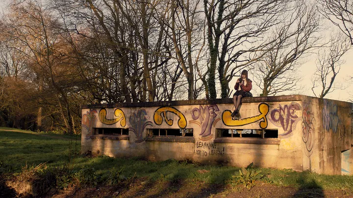 Still from Skive — park bench