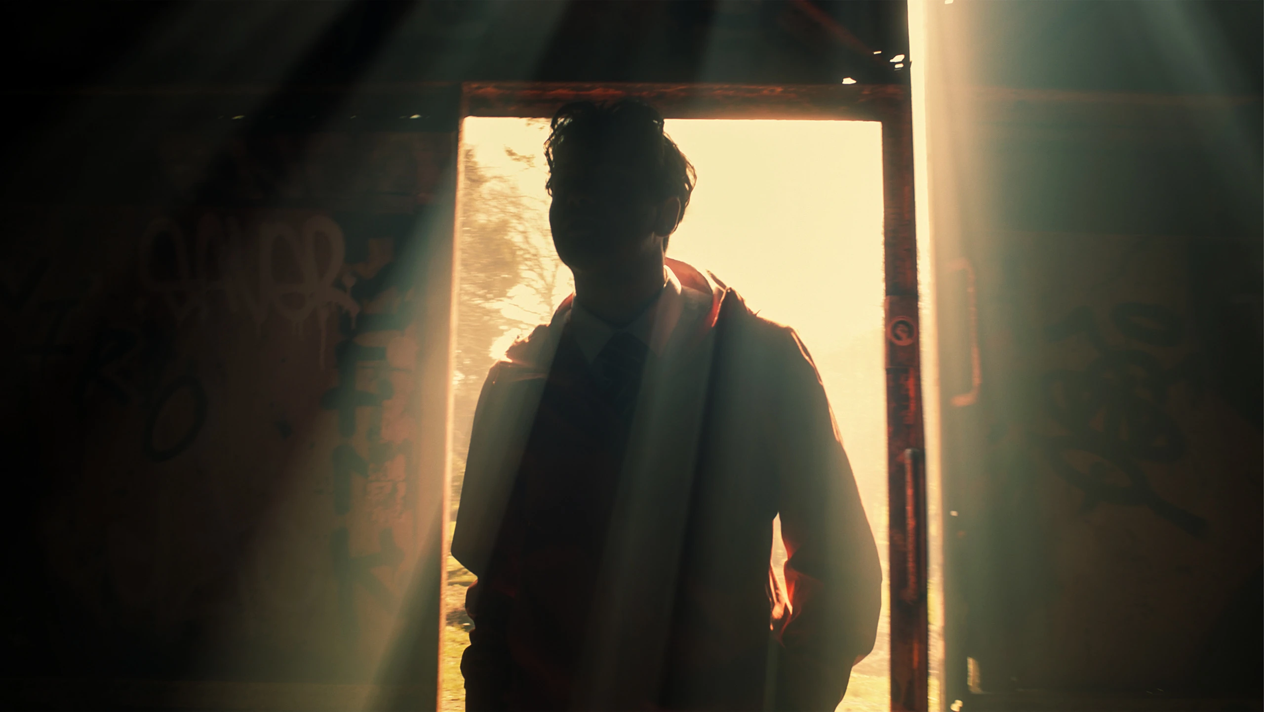 Light streaming through a doorway onto a figure