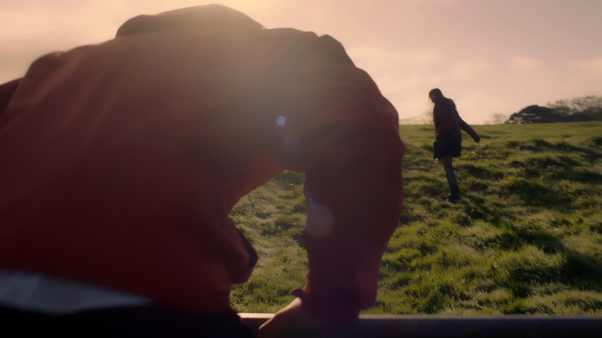 Nathan walking uphill towards Courtney at golden hour
